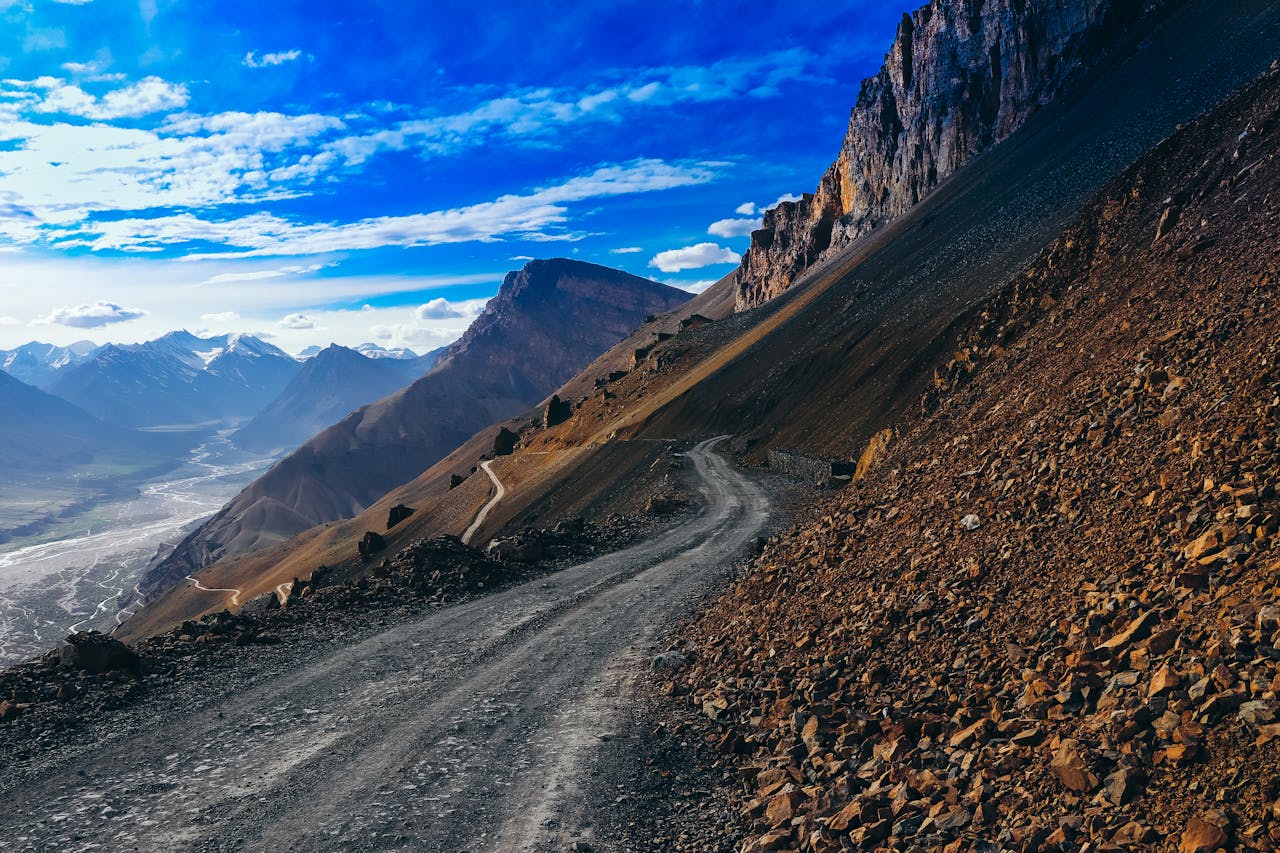 Dirt Road Near Brown Mountains Under Beautiful Sky